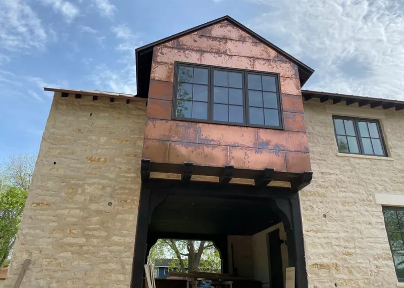 Copper metal panel facade on a stone building for Skylight Installation in Aspen Hill