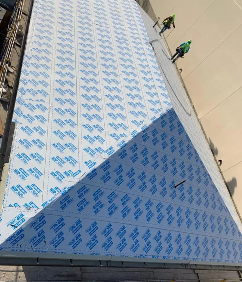 Professional roofers installing underlayment on a metal roof in Aspen Hill